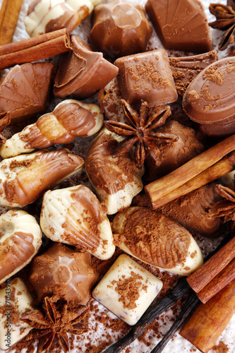 Different kinds of chocolates with spices close-up background