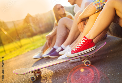 Young peoples legs with skateboard