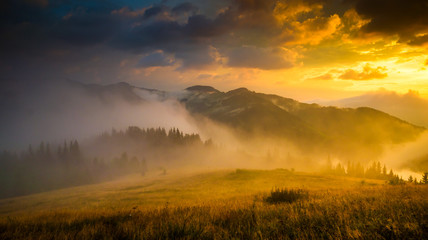 Papier peint photo Photos Amazing mountain landscape with fog and a haystack  © seqoya