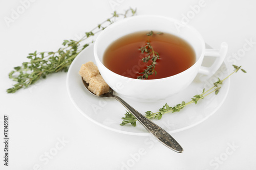 Cup of tasty herbal tea with thyme, isolated on white