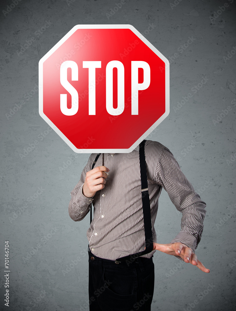 Businessman holding a stop sign Businessman holding a stop sign