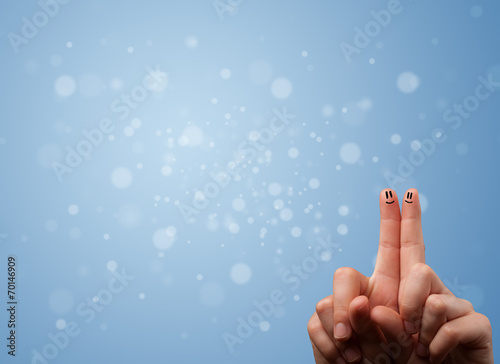 Happy finger smileys with empty blue bokeh background