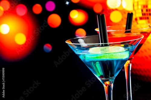 blue cocktail with light disco bokeh background