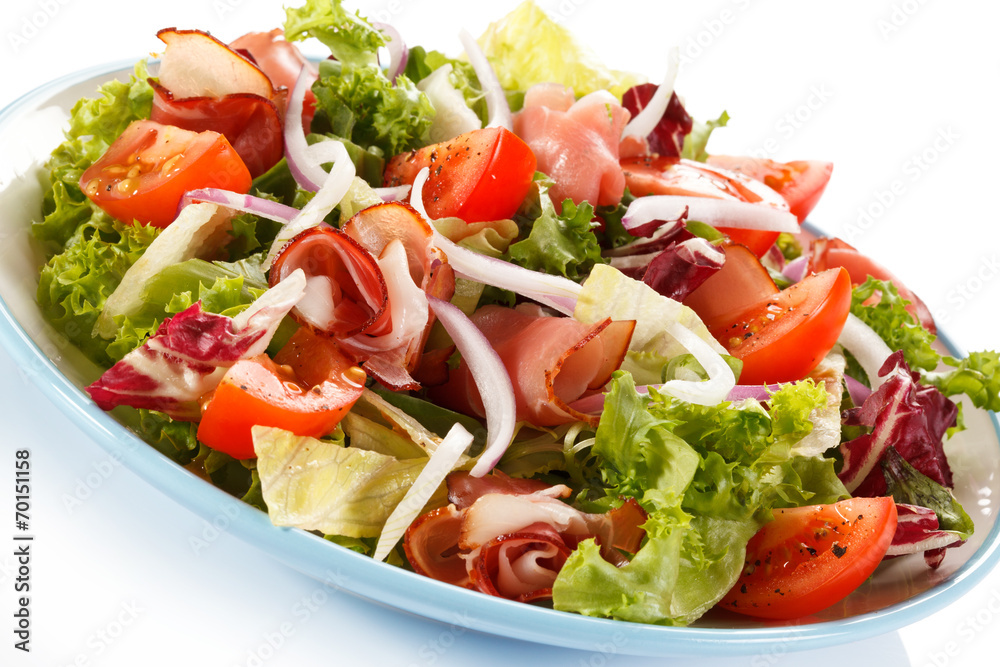 Vegetable salad with ham on white background Vegetable salad with ham on white background
