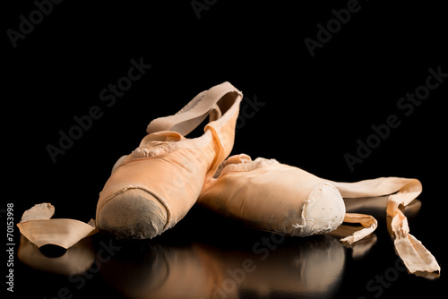 Pair of ballet shoes on a dark background