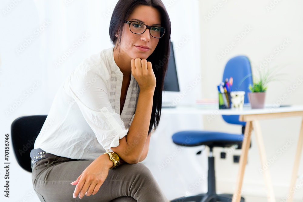Young pretty business woman in her office.