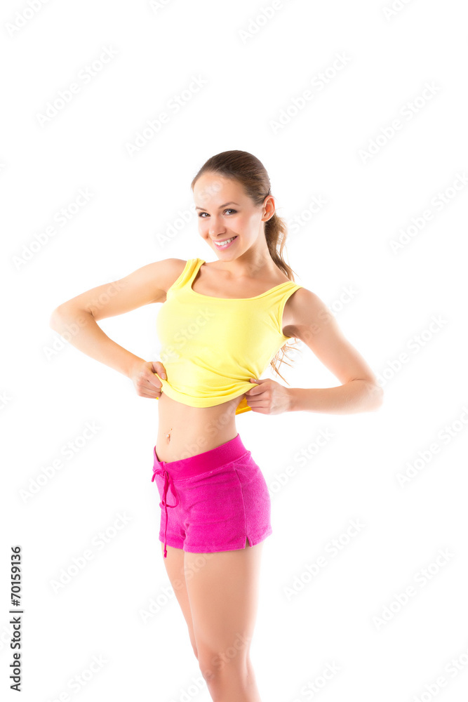 Happy fitness young woman showing a flat stomach in sportswear Happy fitness young woman showing a flat stomach in sportswear