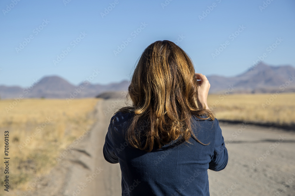 girl turist in Namibia photographing