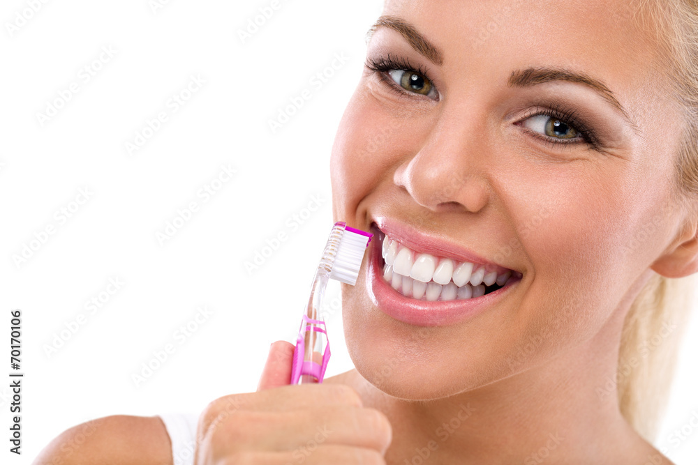 Woman brushing teeth holding toothbrush Woman brushing teeth holding toothbrush
