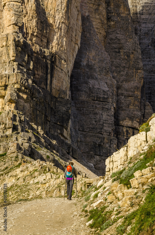 Young woman on a mountain trail, Dolomites Mountains, Italy
