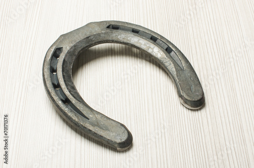 Horseshoe on the bright wooden background