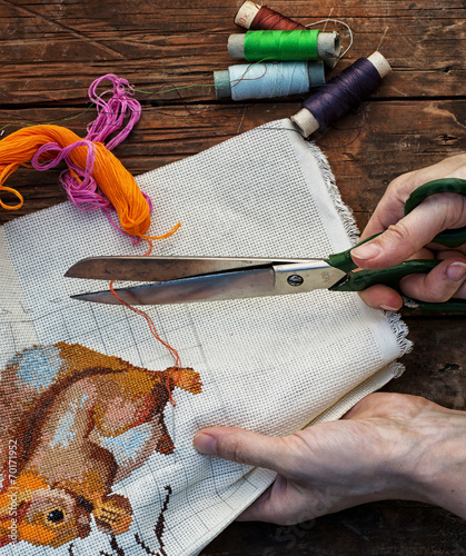 outdated sewing tools on wooden background