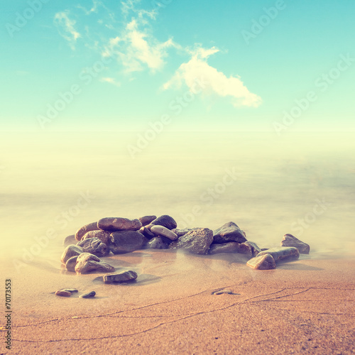 Minimalist misty seascape with rocks at long exposure