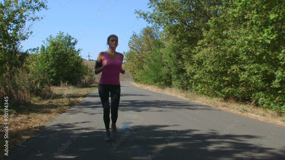 Fitness athletic girl jogging along the road Fitness athletic girl jogging along the road