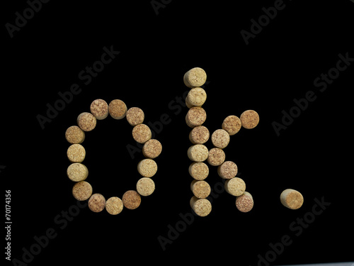 letter O and K lined with wine corks