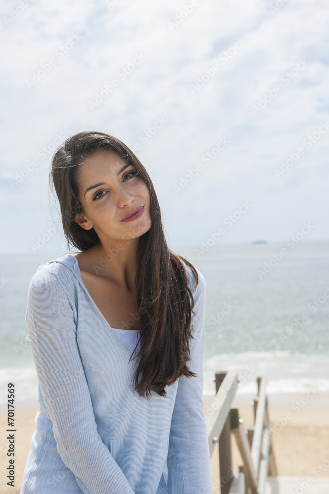portrait of a beautiful woman before the sea in summertime