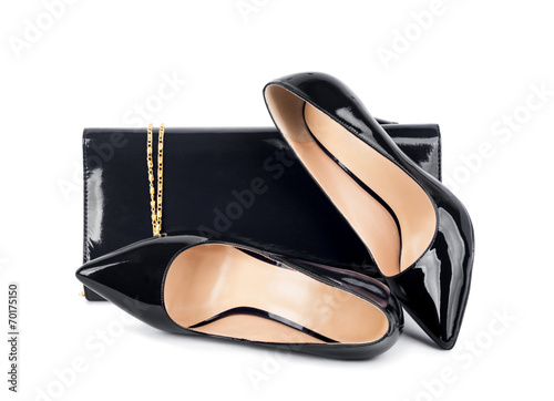 Beautiful black shoes with clutches on white isolated backgroun