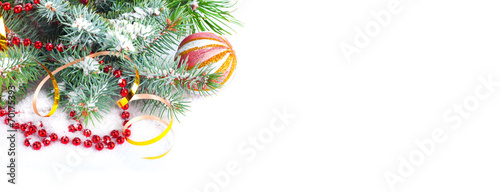 Christmas tree branch with gold serpentine and red sphere on whi