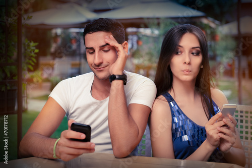 Fotografie, Obraz Secretive Couple with Smart Phones in Their Hands