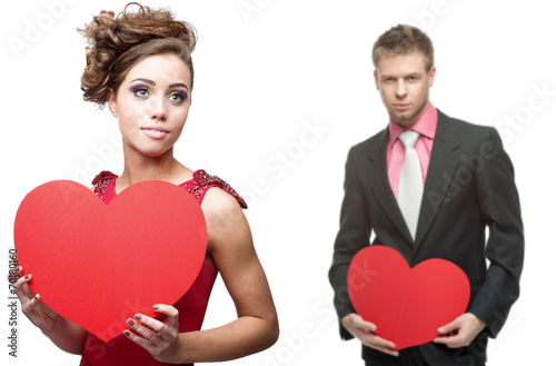 young sensual woman and handsome man holding red heart on white