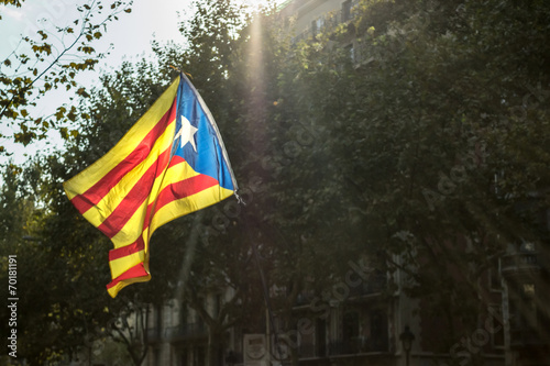 Flag of Catalonia on the Barcelona buildings background photo
