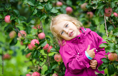 Little girl in the apple garden