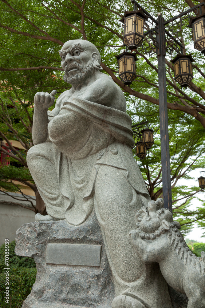 Kungfu master statue with lion.
