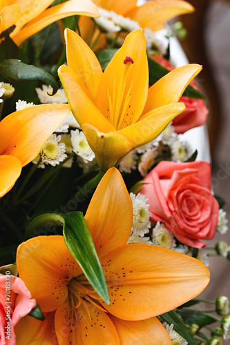 beautiful bridal bouquet of lilies and roses at a wedding party