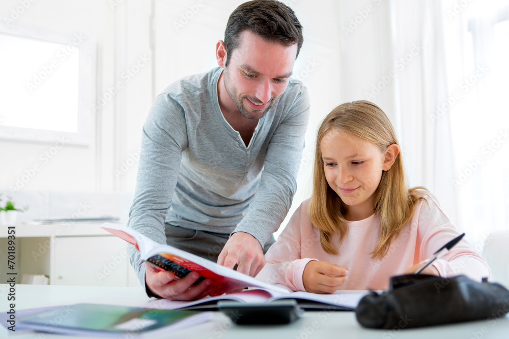 Father helping out her daughter for homework Father helping out her daughter for homework