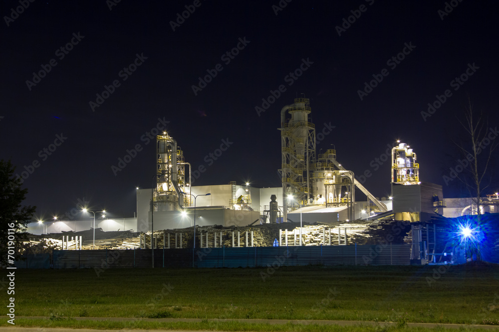 Night image of timber processing plant.