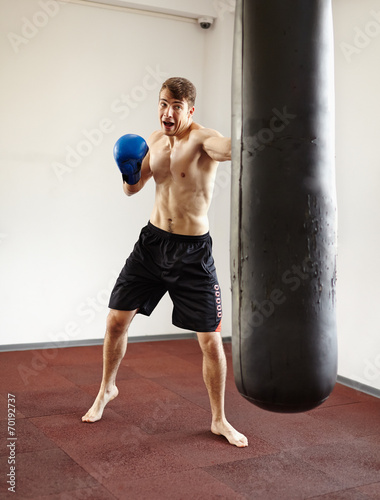 Kickboxer training with punchbag © Xalanx
