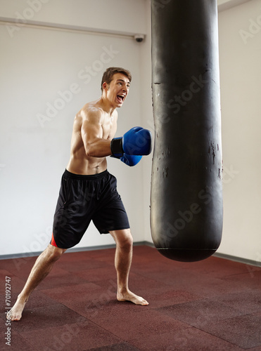 Kickboxer training with punchbag © Xalanx