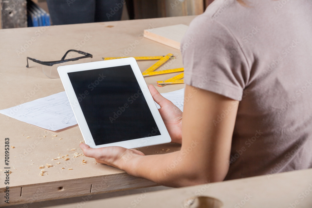 Architect Holding Tablet Computer At Table Architect Holding Tablet Computer At Table