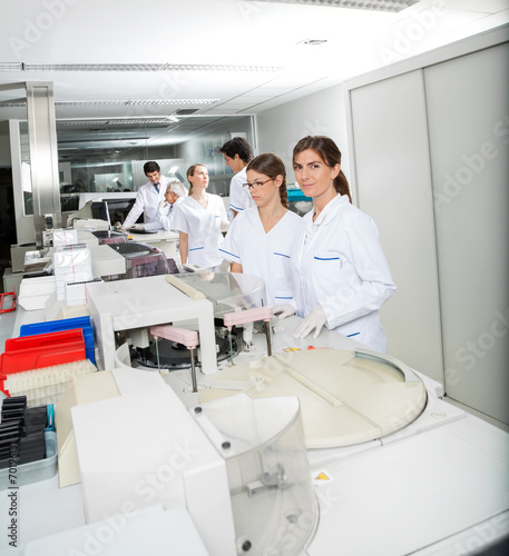 Technician And Colleague Working In Laboratory
