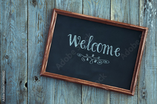 vintage frame WELCOME HOME over blue wooden background