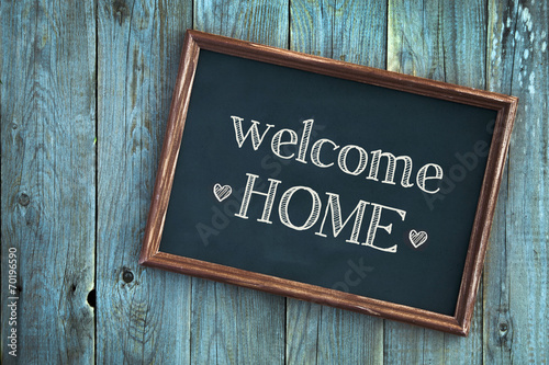 wooden vintage frame WELCOME HOME over wooden background