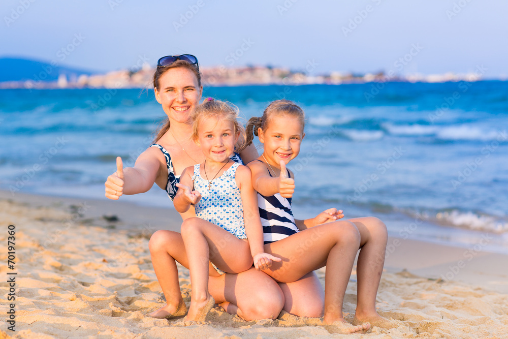 Mother with her daughters at the seashore