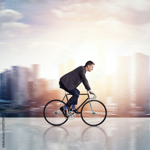Fototapeta Naklejka Na Ścianę i Meble -  Businessman on a bicycle