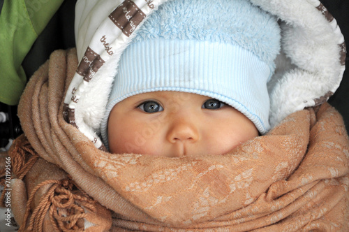 Baby in warm clothes in cold weather