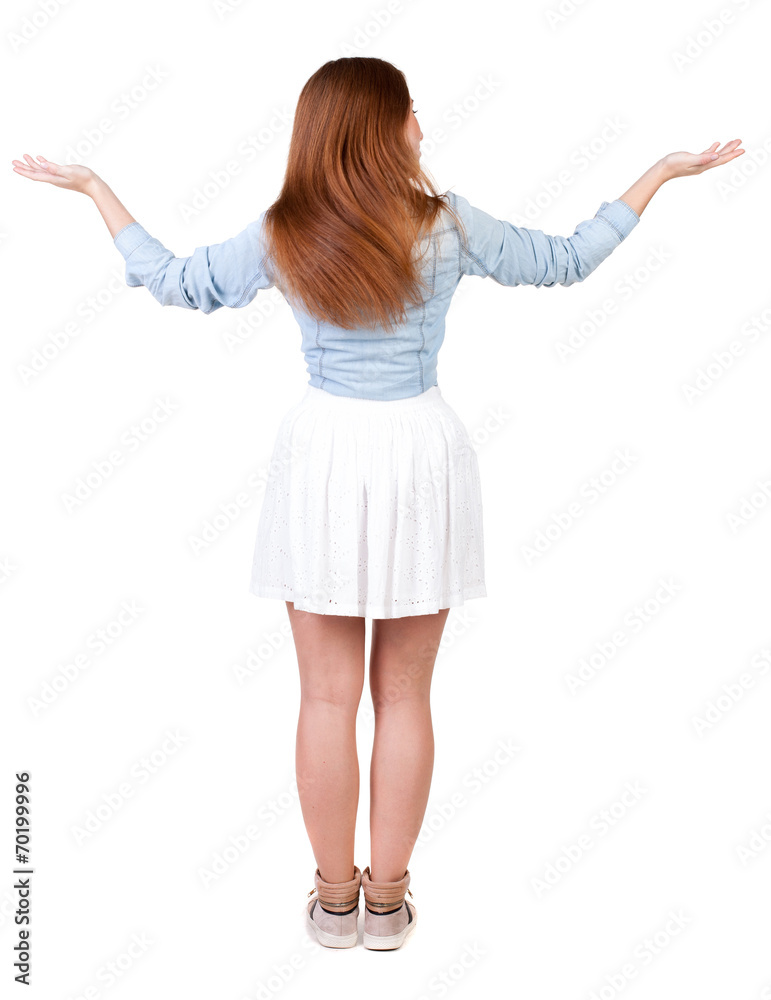 Back view of Beautiful woman in dress looking at wall and Holds Back view of Beautiful woman in dress looking at wall and Holds