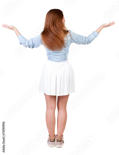 Back view of Beautiful woman in dress looking at wall and Holds