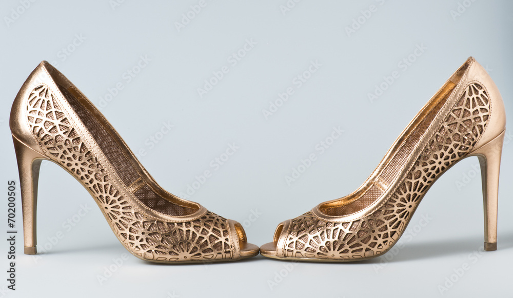 Obraz premium Woman gold shoes on background