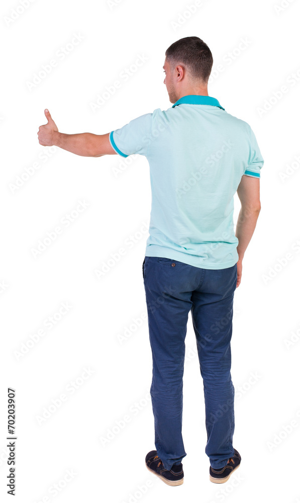 Back view of man in checkered shirt shows thumbs up. Back view of man in checkered shirt shows thumbs up.