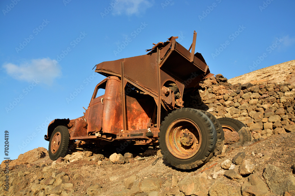 Obraz premium derrumbe de un muro de piedra sobre un vehiculo