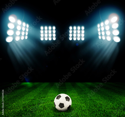 Soccer ball on the field of stadium with light © ZaZa studio