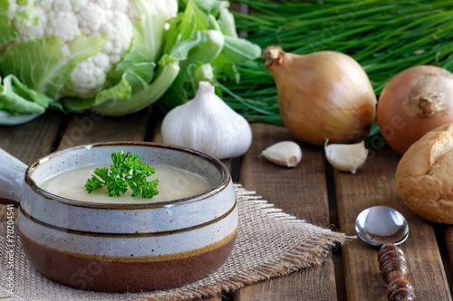 Fresh cauliflower soup with onions, garlic and parsley photo