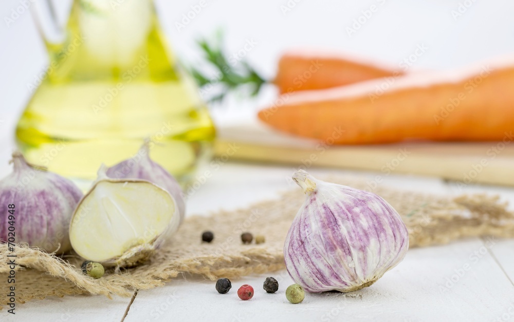 Garlic bulbs and cooking ingredients on kitchen table