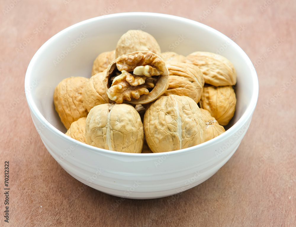 walnuts in a white bowl walnuts in a white bowl