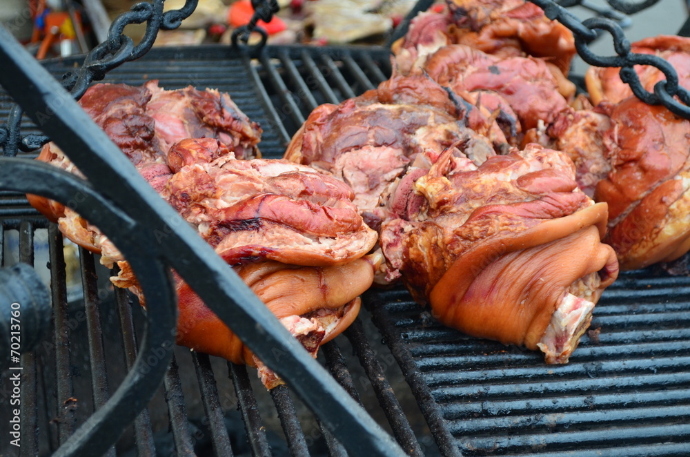 Grilling pork on barbecue grill