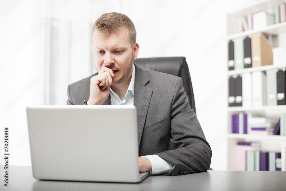Concerned businessman working at his desk Concerned businessman working at his desk